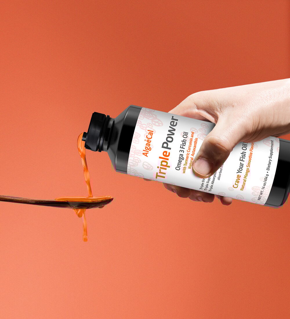 Pouring Triple Power Fish Oil into a spoon