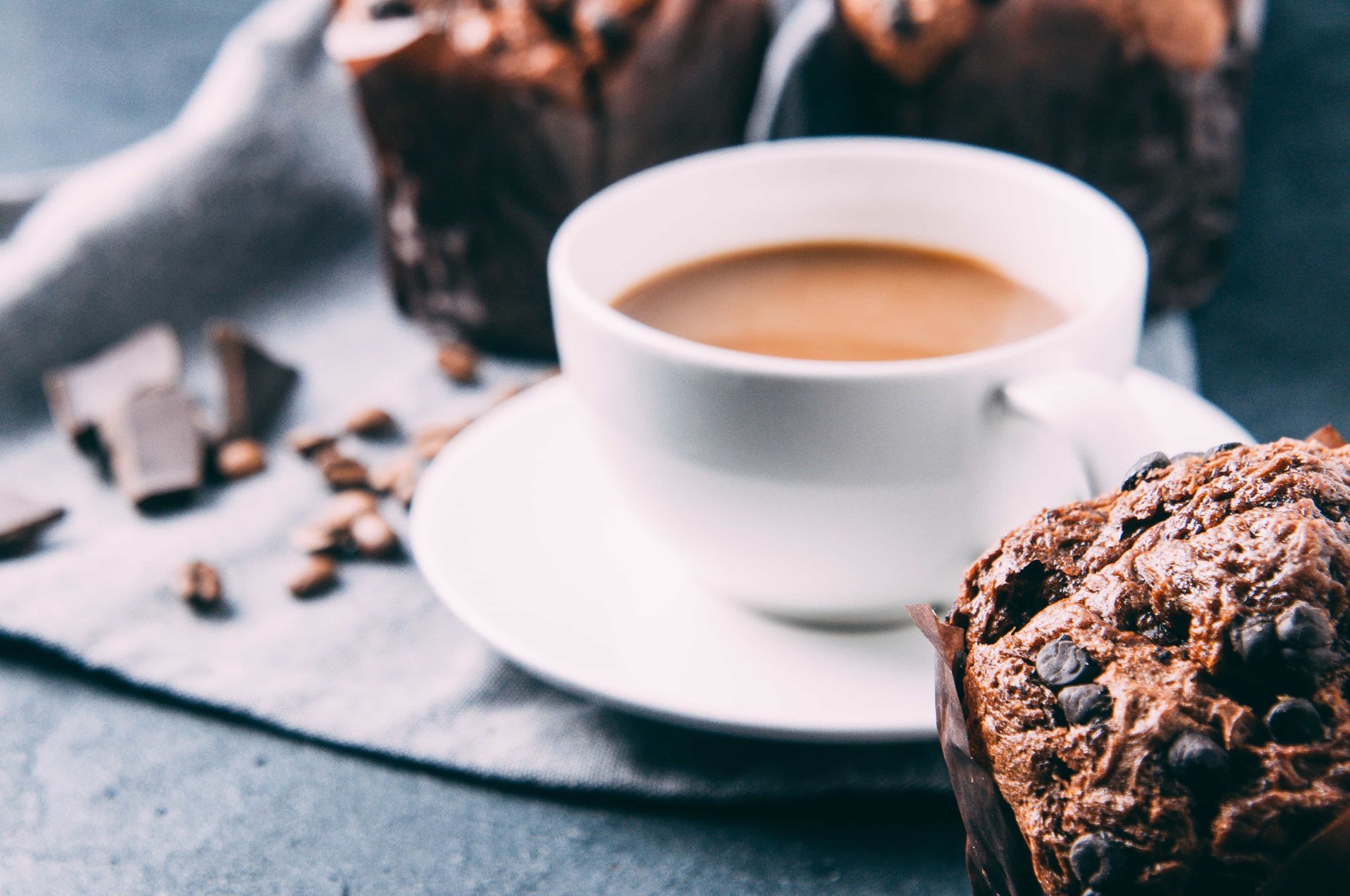 Chocolate muffins and coffee on a dark background