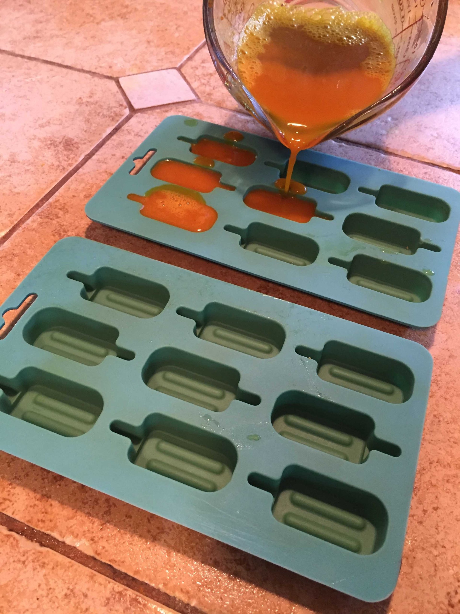 turmeric gummies being poured into molds