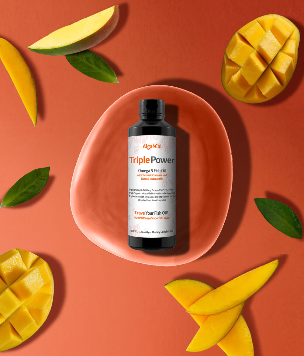 Bottle of Triple Power Fish Oil surrounded by mango