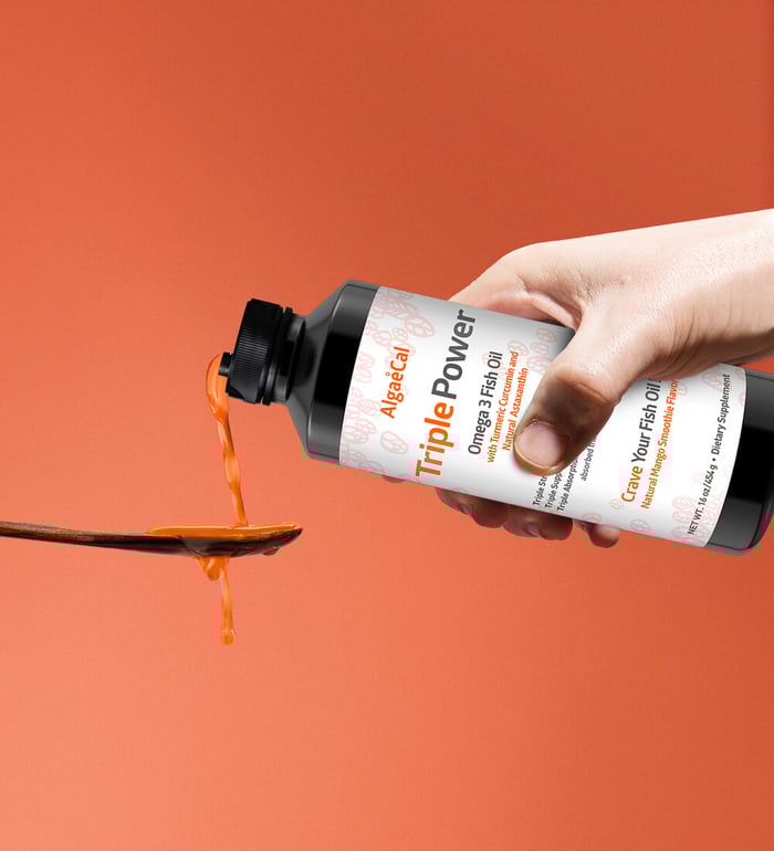 Pouring Triple Power Fish Oil into a spoon