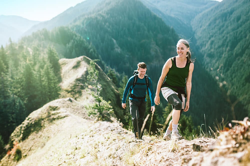 Woman and man hiking on a trail